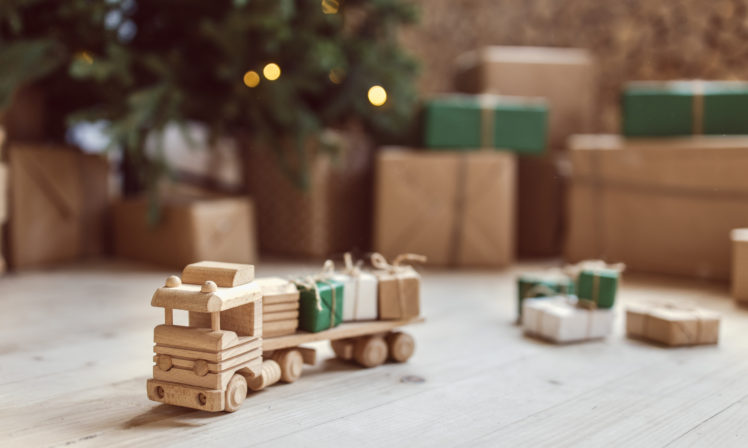 Wooden toy car with christmas gift boxes on top